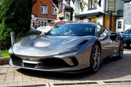 Luxurious gray Ferrari sports car parked in a picturesque city street.